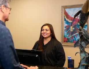 Tropical Dental Care patient talking with staff member